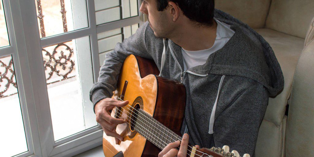 Man playing guitar in Veteran Alcohol Rehab
