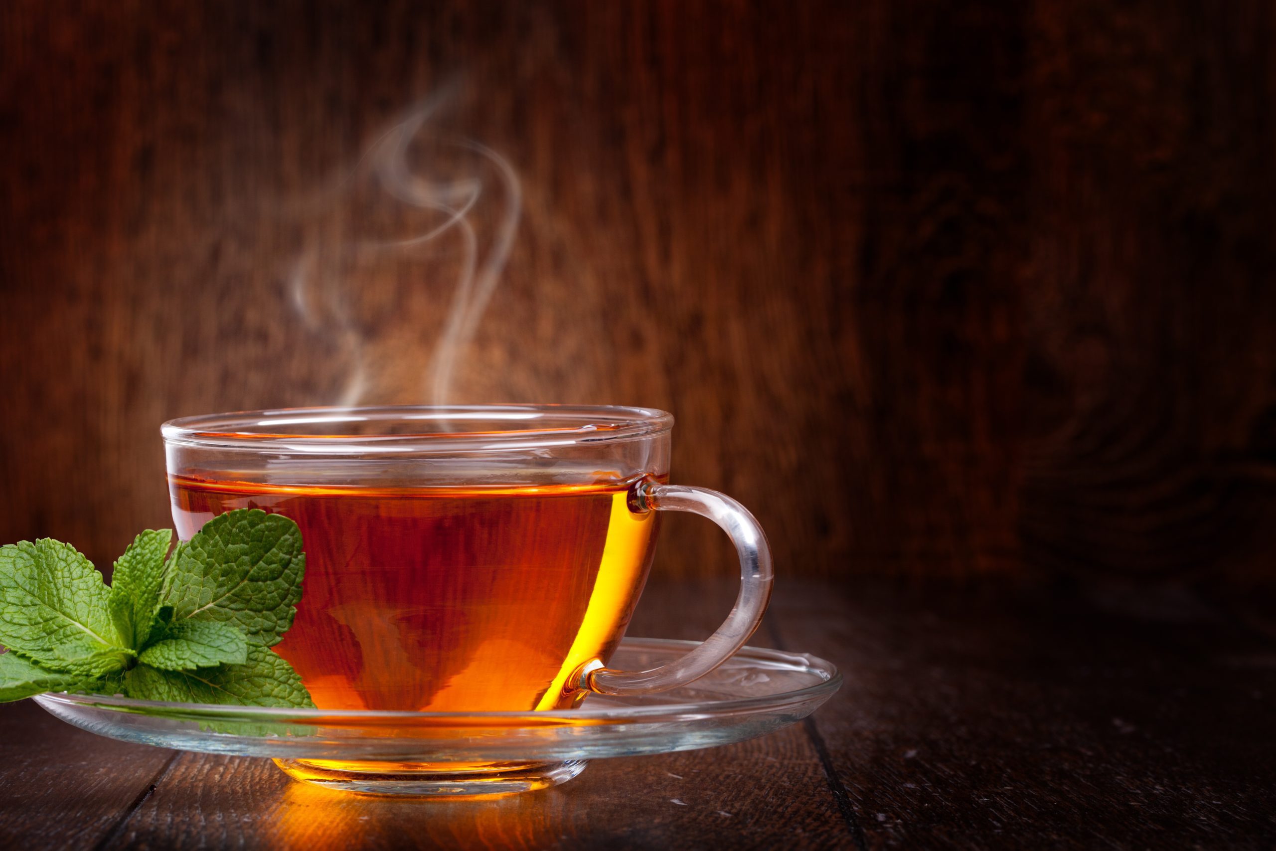 Cup,of,tea,and,mint,on,a,wooden,background